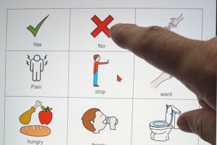 stroke survivor using communication board